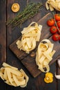 Italian food ingredients pasta, on old dark  wooden table background, top view flat lay Royalty Free Stock Photo