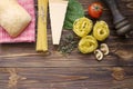 Italian food ingredients: pasta, tomato, spinach, pepper, porcini on wooden background Royalty Free Stock Photo