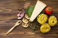 Italian food ingredients: pasta, tomato, spinach, pepper, porcini on wooden background Royalty Free Stock Photo