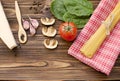 Italian food ingredients: pasta, tomato, spinach, pepper, porcini on wooden background Royalty Free Stock Photo