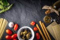 Italian food mix on the black stone table top view