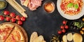 Italian food panorama with copy space. Pizza, pasta, cheese, ham, wine, olives, pesto, capers Royalty Free Stock Photo