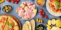 Italian food panorama. Pizza, pasta, cheese, ham, capers, wine, tomatoe etc Royalty Free Stock Photo