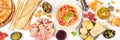 Italian food panorama. Pizza, pasta, cheese, hams, olives, wine and olive oil, shot from the top on a white background Royalty Free Stock Photo