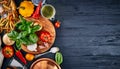 Italian food. Pasta basil tomato and olive oil on wooden black blackboard rustic style top view wiith copyspace. Royalty Free Stock Photo