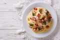 Italian food: pasta carbonara on the table. horizontal top view