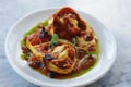 italian food pasta dish lobster stuffed ravioli with saffron tomato sauce in close up on a dining table Royalty Free Stock Photo