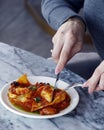 italian food pasta dish lobster stuffed ravioli with saffron tomato sauce in close up on a dining table Royalty Free Stock Photo