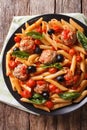 Italian Food: Pasta with meatballs, olives and tomato sauce closeup. Vertical top view Royalty Free Stock Photo