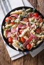 Italian food: penne pasta with salami, cheese, and vegetables cl Royalty Free Stock Photo