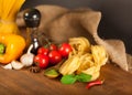 Pasta spaghetti, vegetables and spices, on wooden Royalty Free Stock Photo