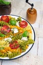 Italian food - Salad with colorful pasta, cherry tomatoes, feta cheese and fresh basil Royalty Free Stock Photo