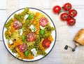 Italian food - Salad with colorful pasta, cherry tomatoes, feta cheese and fresh basil Royalty Free Stock Photo