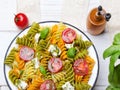 Italian food - Salad with colorful pasta, cherry tomatoes, feta cheese and fresh basil Royalty Free Stock Photo