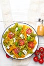 Italian food - Salad with colorful pasta, cherry tomatoes, feta cheese and fresh basil Royalty Free Stock Photo