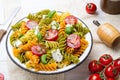 Italian food - Salad with colorful pasta, cherry tomatoes, feta cheese and fresh basil Royalty Free Stock Photo