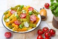 Salad with colorful pasta, cherry tomatoes, feta cheese and fresh basil Royalty Free Stock Photo