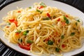 Italian food spaghetti Aglio e Olio with fried garlic, parsley and hot pepper close-up in a plate. horizontal Royalty Free Stock Photo