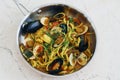 italian food speciality pasta dish, seafood linguine with mussels, clams, squid, scallops and prawns in tomato saffron sauce Royalty Free Stock Photo