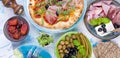 Italian food on the table, pizza and antipasto. Beautiful serving for a family dinner. Olives and basil. Cheese and ham Royalty Free Stock Photo