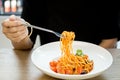 Italian food woman eating spaghetti with fork in the white plate Royalty Free Stock Photo