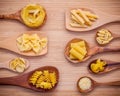 Italian foods concept and menu design . Various kind of Pasta Elbow Macaroni ,Farfalle ,Rigatoni ,gnocco Sardo in wooden spoons s Royalty Free Stock Photo