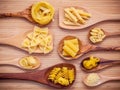 Italian foods concept and menu design . Various kind of Pasta Elbow Macaroni ,Farfalle ,Rigatoni ,gnocco Sardo in wooden spoons s Royalty Free Stock Photo