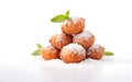 Italian fritters piled high, dusted with powdered sugar and fresh mint, a carnival favorite, white background. Sweet stack of