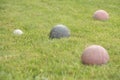 italian game bocce, old worn set of balls with one green and two red in shot Royalty Free Stock Photo