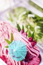 Italian gelato raspberry ice cream with blue umbrella