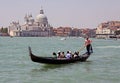 Italian gondolier and tourists