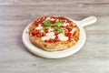 Italian gourmet pizza on wooden chopping board