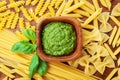 Italian green pesto sauce and mixed raw pasta top view. Food concept. Royalty Free Stock Photo