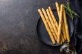 Italian grissini bread sticks and rosemary on kitchen table. Top view