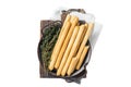 Italian grissini bread sticks in steel tray with herbs. Isolated, white background. Royalty Free Stock Photo