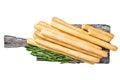 Italian grissini or salted bread sticks on wooden board. Isolated, white background. Royalty Free Stock Photo