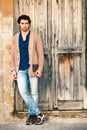 Italian handsome man model near an ancient wooden door Royalty Free Stock Photo