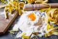 Italian homemade pasta with wheat flour and egg on black background Royalty Free Stock Photo