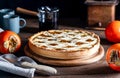 Italian homemade persimmon tart or crostata with persimmon fruits, coffee on the wooden table, chiaroscuro style