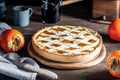 Italian homemade persimmon tart or crostata with persimmon fruits, coffee on the wooden table, chiaroscuro style