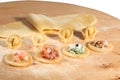 Italian homemade tortellini,open and closed,filled with ricotta cheese,shrimp,prosciutto,fresh spinach and walnuts.