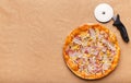 Italian Hot Pizza And Cutter On Craft Paper Background Royalty Free Stock Photo