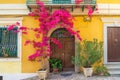 Italian house exterior with bougainvillea flowers on the wall around the doors in town Positano, Amalfi coast, Campania Royalty Free Stock Photo