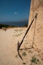 Sardinia, Italy. Old anchor against a wall, historic defensive tower