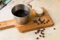 Italian lack coffee in a cup with coffee beans and a handmade cookie with sugar and a moka pot behind. Everything in vintage brown Royalty Free Stock Photo