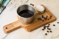 Italian lack coffee in a cup with coffee beans and a handmade cookie with sugar and a moka pot behind. Everything in vintage brown Royalty Free Stock Photo