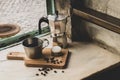 Italian lack coffee in a cup with coffee beans and a handmade cookie with sugar and a moka pot behind. Everything in vintage brown Royalty Free Stock Photo