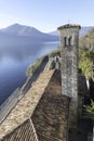 Italy lakes scene stone square turret of traditional stone building, day blue sky clear