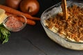 Italian Lasagna on a black background with ingredients. Cooking time. Recipe book and home menu Royalty Free Stock Photo