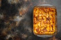Italian Lasagne with tomato bolognese sauce and mince beef meat, in baking tray, on old dark rustic background, top view, flat lay Royalty Free Stock Photo